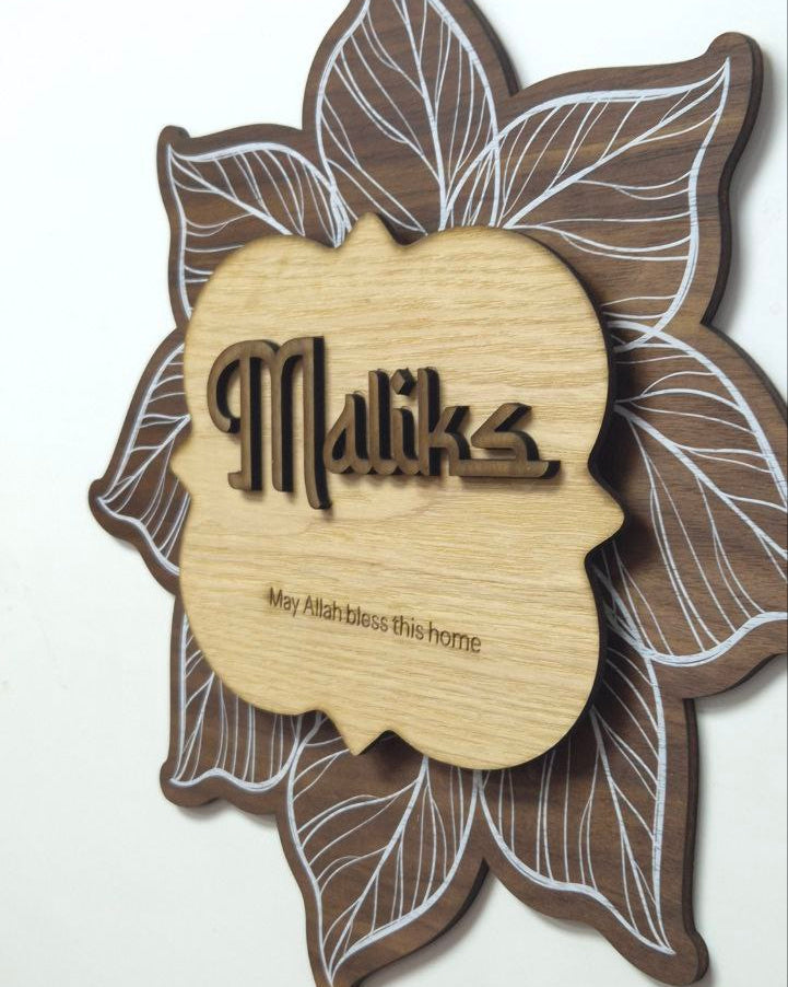 Decorative wooden plaque with leaf design and surname