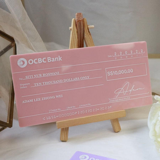 Pink cheque on a wooden stand with a white background for hantaran needs